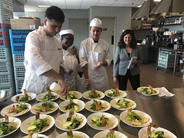 Students plating food in foos and hospitality management class